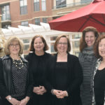 The Kensington Falls Church Team of Directors Standing Together Against a Backdrop of the City of Falls Church.