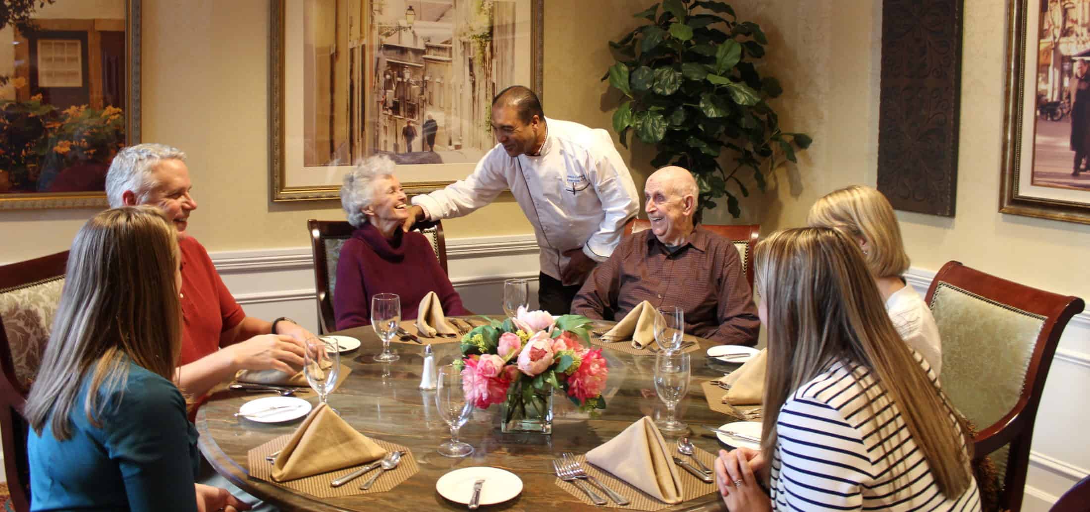 Chef Samir with Kensington Falls Church Family in dining room