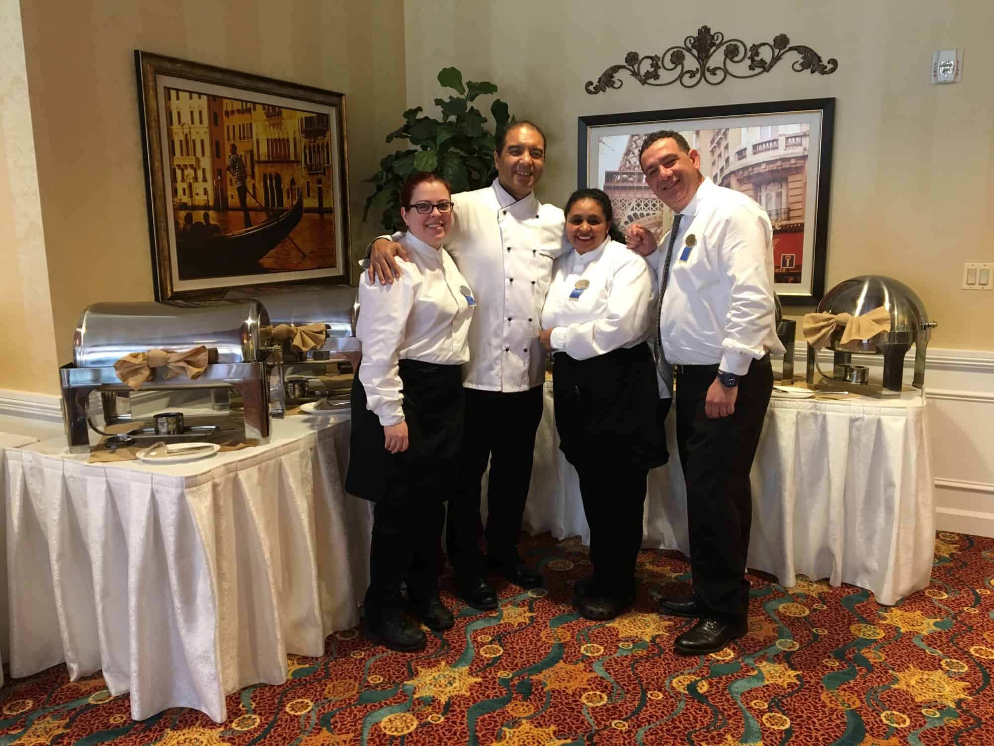 Samir and dining team in front of Buffet.