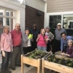 A group shot of Kensington Falls Church assisted living and memory care residents gardening