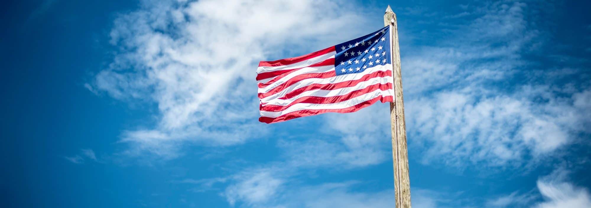 american flag against blue sky on memorial day