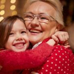 grandmother and granddaughter hugging at the holidays