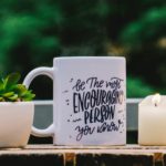 Be The Most Encouraging Person You Know mug with potted succulent and candle.