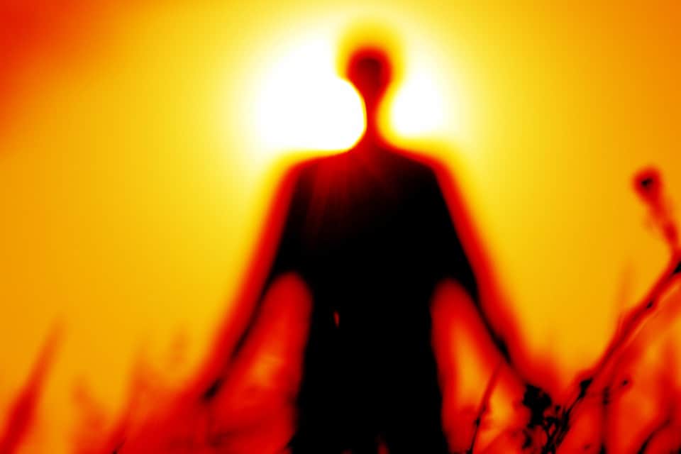 Silhouette of a person against sun.