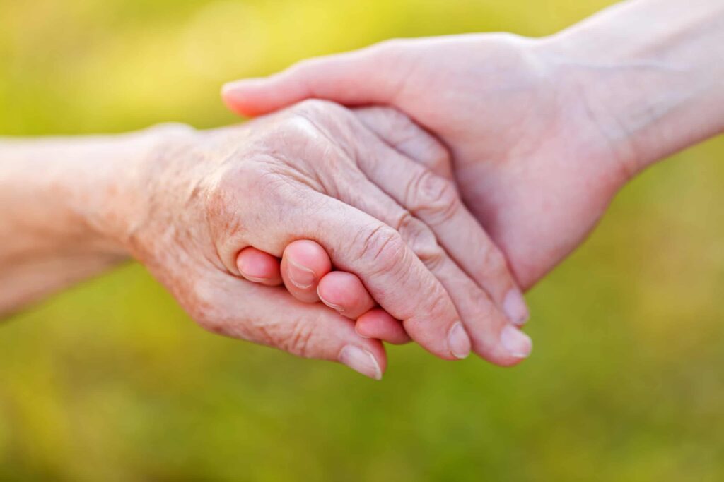 Handshake against a green background.