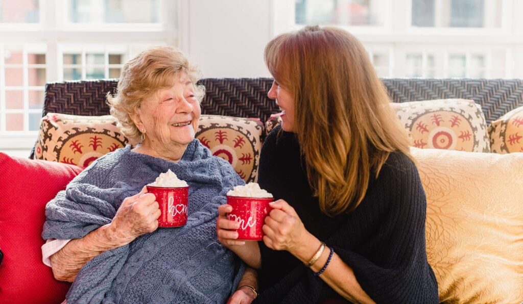 mother and daughter sipping hot cocoa