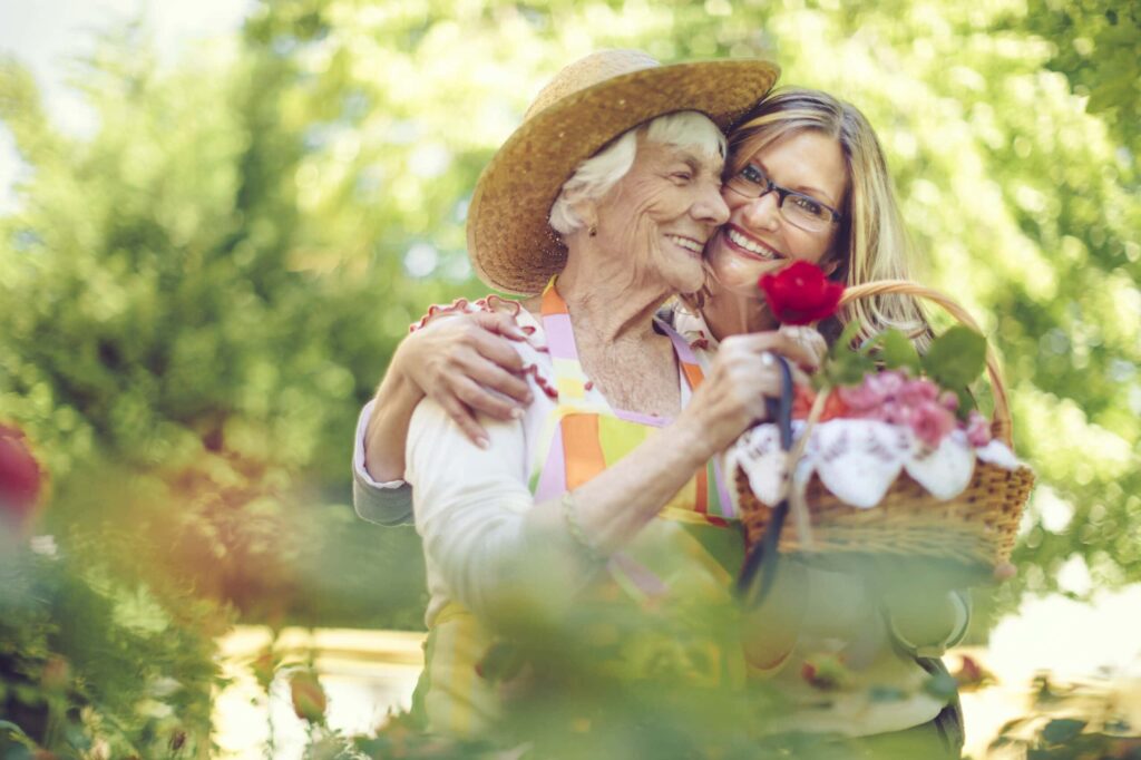 senior mother aging daughter gardening