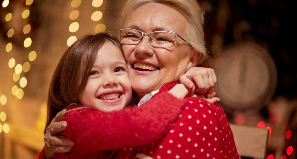 grandmother and granddaughter hugging at the holidays