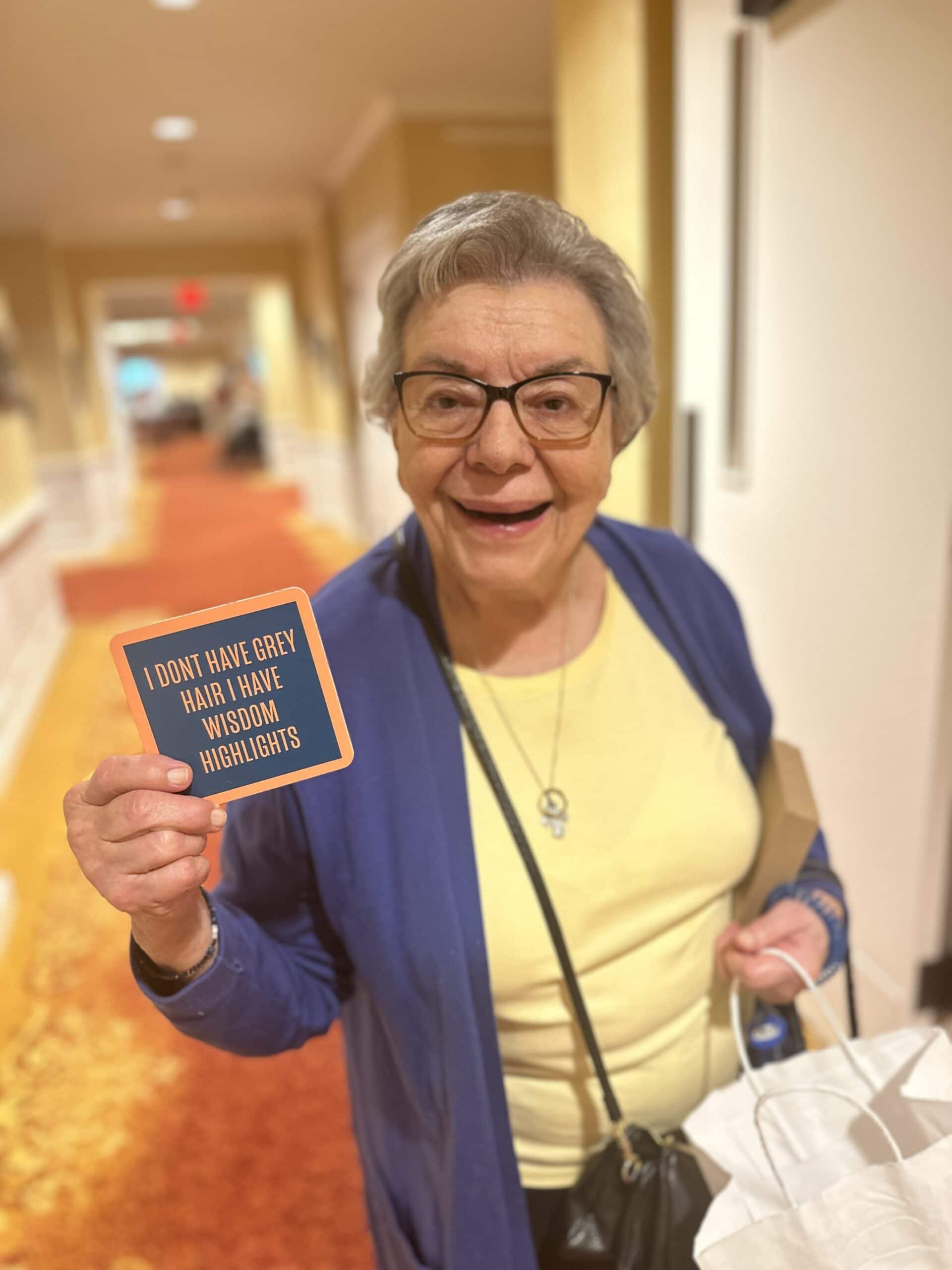 resident smiling with sign