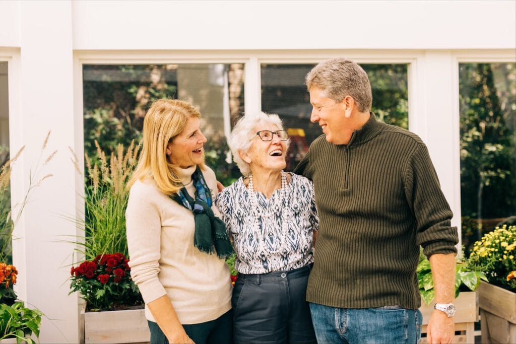 man and woman with older woman smiling