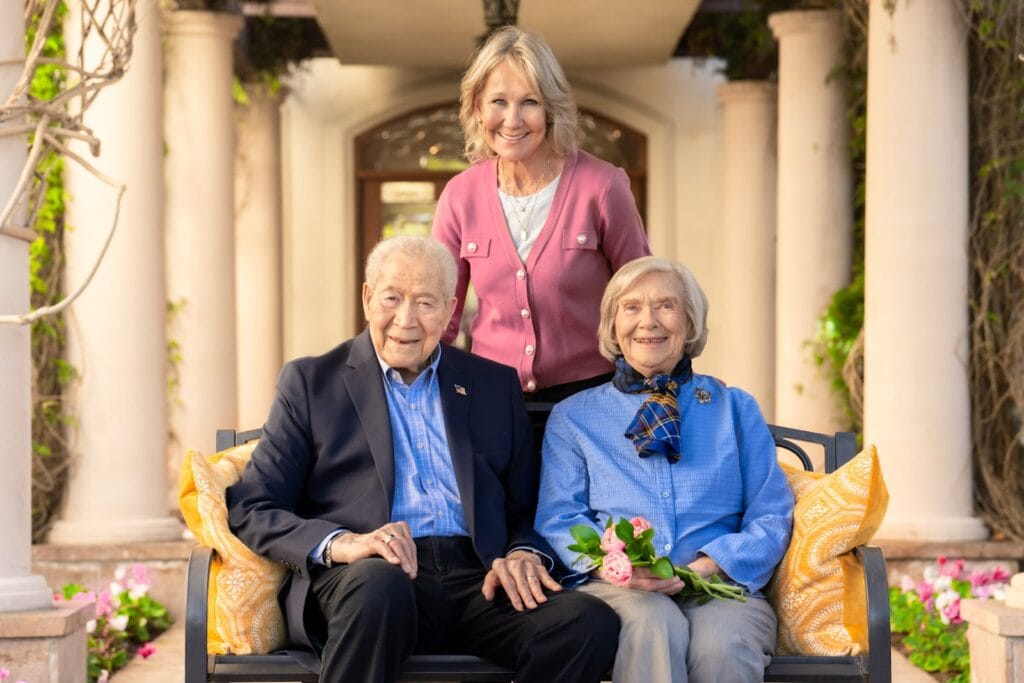older couple with woman sitting for a picture