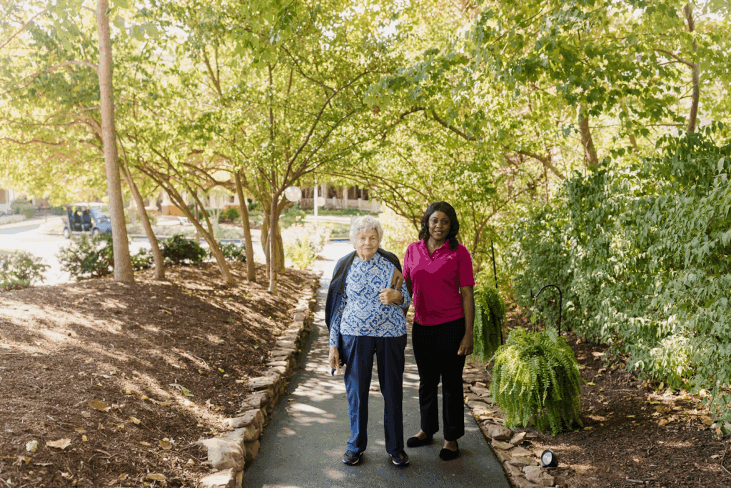 an older woman and younger woman walking on a sidewalk together