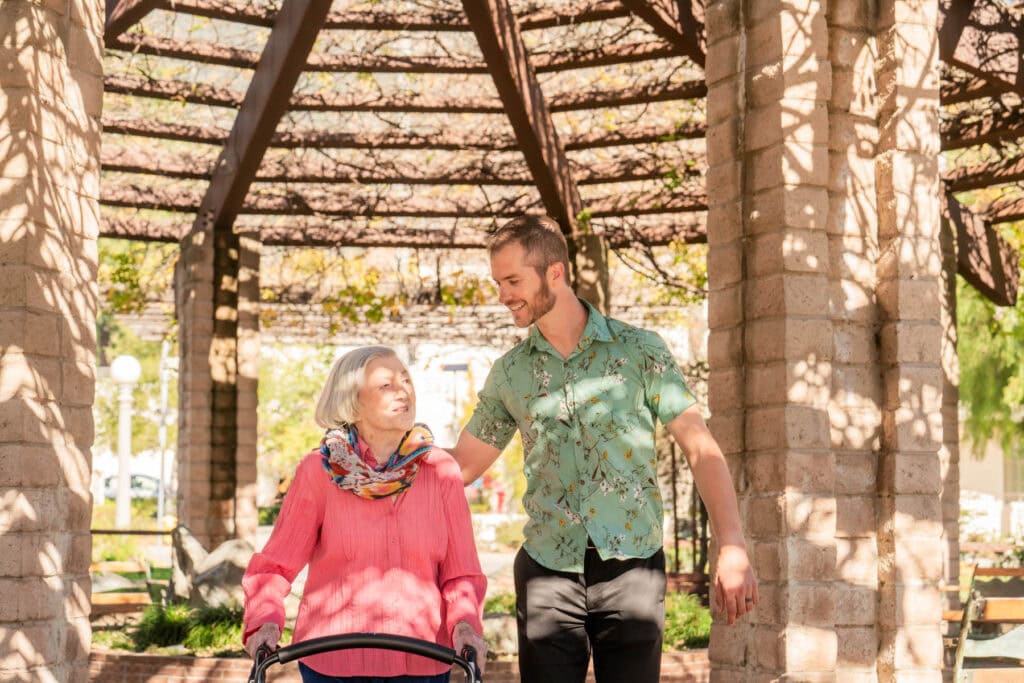 resident walking with caregiver
