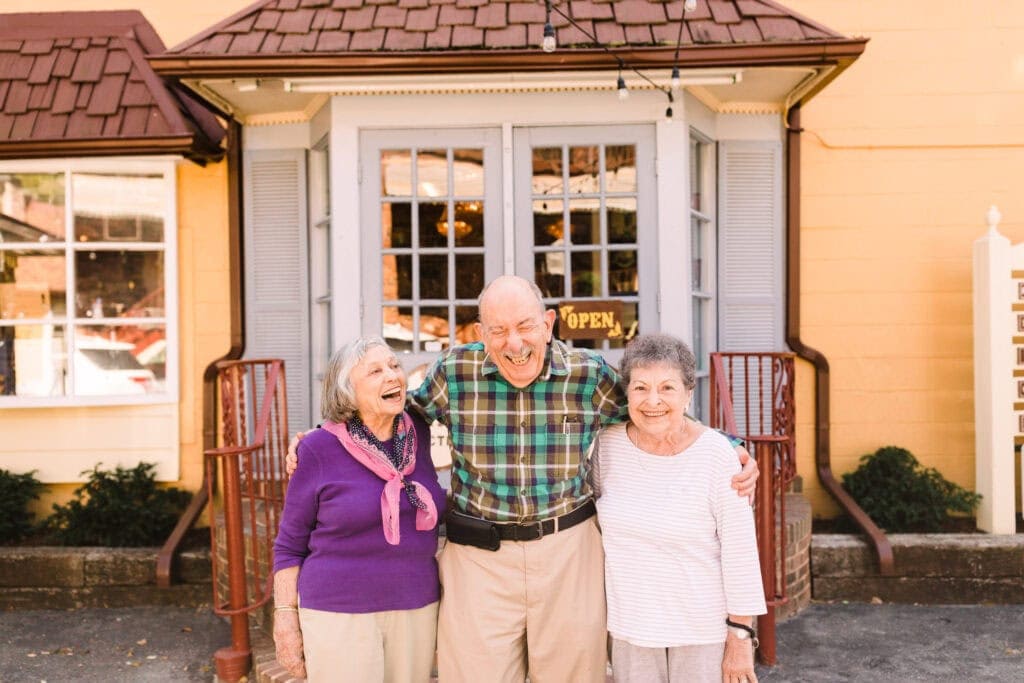 older man with two older women laughing together