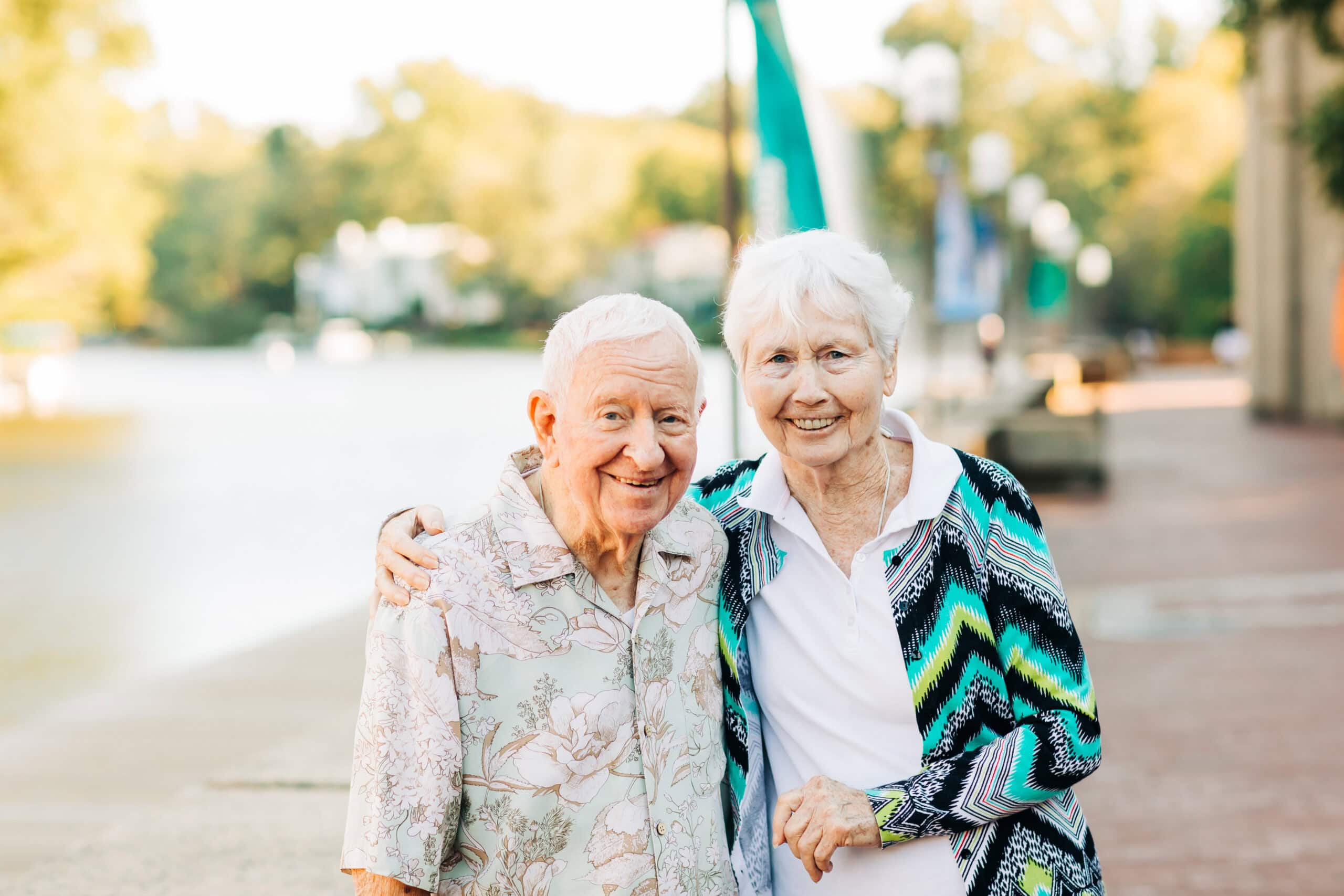 senior couple walking by the lake